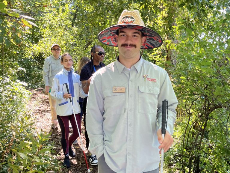 Let's Go Birding Interns guiding a group of event participants through a nature trail.